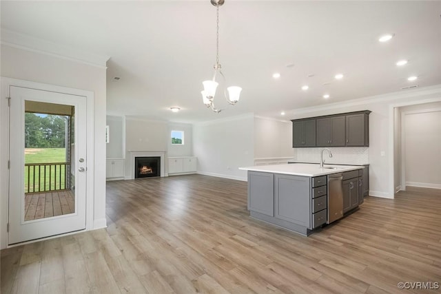8124 Clancy Ct, Chesterfield, VA 23838 - kitchen featuring crown molding, light countertops, stainless steel dishwasher, a kitchen island with sink, and light wood-style flooring