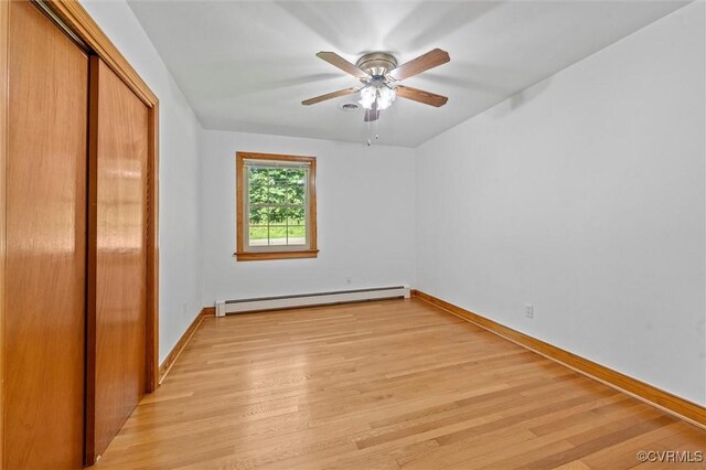 2001 Hicks Rd, North Chesterfield, VA 23235 - unfurnished bedroom with baseboard heating, light wood finished floors, a closet, and ceiling fan