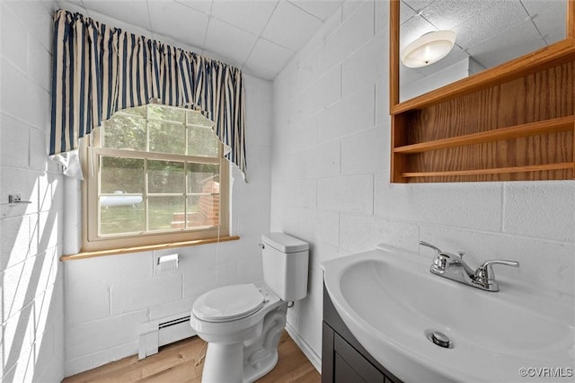 2001 Hicks Rd, North Chesterfield, VA 23235 - half bath with a baseboard radiator, vanity, wood finished floors, and concrete block wall