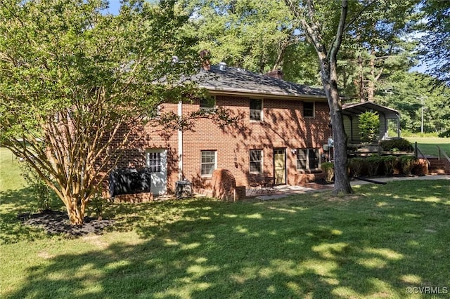 2001 Hicks Rd, North Chesterfield, VA 23235 - back of property featuring a lawn, brick siding, and a chimney