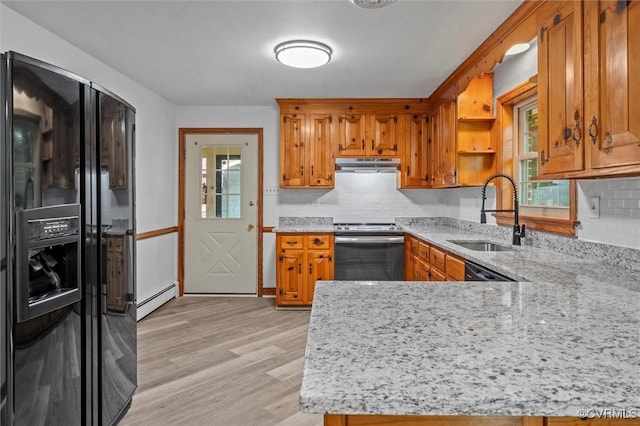 2001 Hicks Rd, North Chesterfield, VA 23235 - kitchen with black refrigerator with ice dispenser, stainless steel range with electric cooktop, under cabinet range hood, a baseboard radiator, and brown cabinets