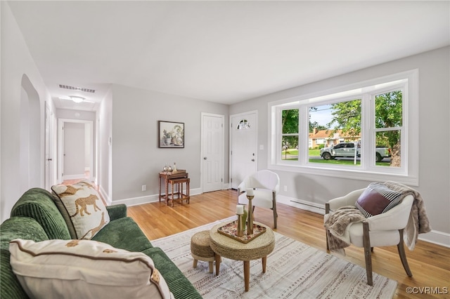 4308 Sunset Dr, North Dinwiddie, VA 23803 - living room with light wood-style floors and a baseboard heating unit