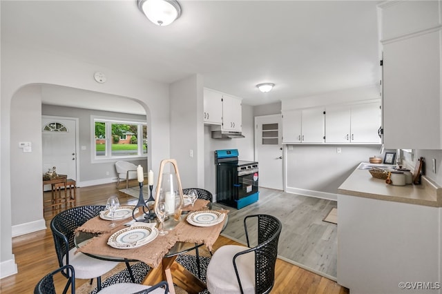 4308 Sunset Dr, North Dinwiddie, VA 23803 - dining space featuring arched walkways and light wood-type flooring