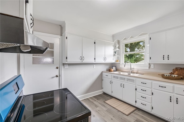 4308 Sunset Dr, North Dinwiddie, VA 23803 - kitchen featuring black / electric stove, range hood, light wood-type flooring, white cabinets, and light countertops
