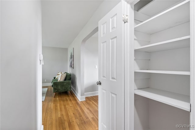 4308 Sunset Dr, North Dinwiddie, VA 23803 - hallway featuring light wood-type flooring and arched walkways