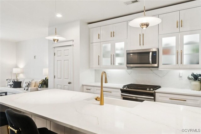 14424 Michaux Village Dr, Midlothian, VA 23113 - kitchen featuring appliances with stainless steel finishes, pendant lighting, light stone countertops, white cabinetry, and recessed lighting