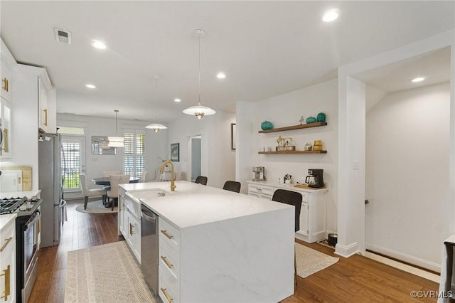 14424 Michaux Village Dr, Midlothian, VA 23113 - kitchen with appliances with stainless steel finishes, an island with sink, white cabinets, dark wood finished floors, and recessed lighting