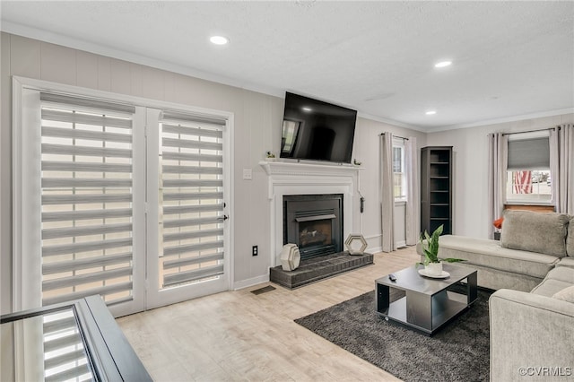 14210 Cherry St, Chester, VA 23831 - living area featuring ornamental molding, healthy amount of natural light, wood finished floors, a fireplace with raised hearth, and recessed lighting