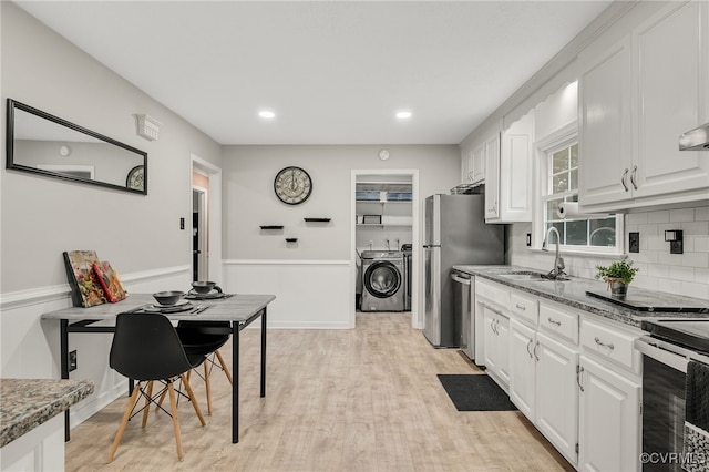 14210 Cherry St, Chester, VA 23831 - kitchen with washing machine and clothes dryer, white cabinetry, tasteful backsplash, stainless steel appliances, and light stone counters