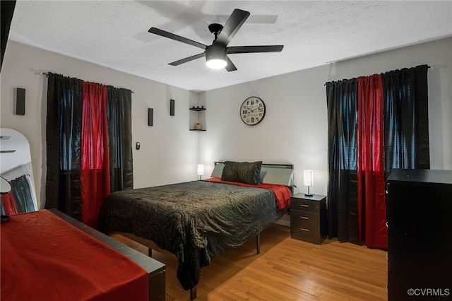 14210 Cherry St, Chester, VA 23831 - bedroom featuring light wood-type flooring, a textured ceiling, and a ceiling fan