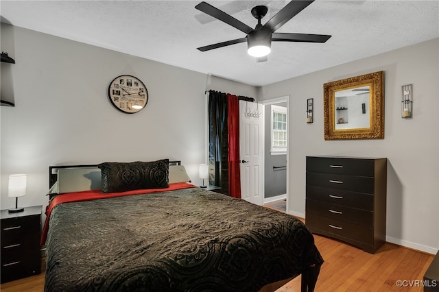 14210 Cherry St, Chester, VA 23831 - bedroom featuring light wood finished floors, a textured ceiling, and a ceiling fan