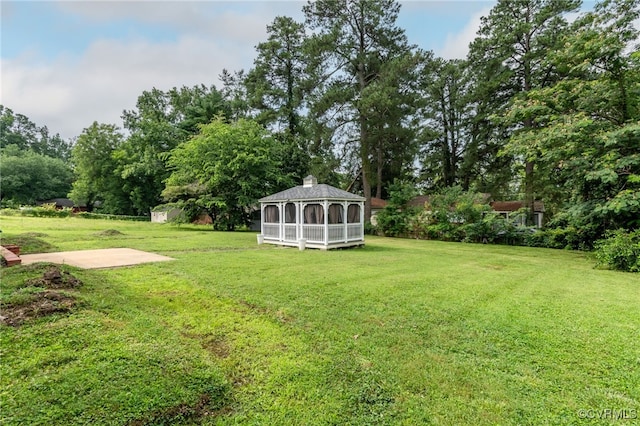 14210 Cherry St, Chester, VA 23831 - view of green lawn with a gazebo, a storage unit, and view of wooded area