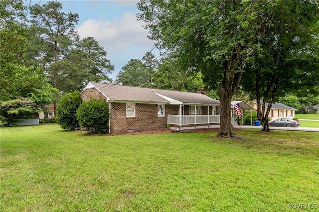14210 Cherry St, Chester, VA 23831 - view of front facade with brick siding, a front lawn, a chimney, driveway, and a detached carport