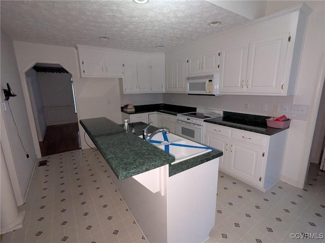 12703 Colby Cove Ct, Chester, VA 23831 - kitchen with white appliances, dark countertops, white cabinets, a textured ceiling, and recessed lighting