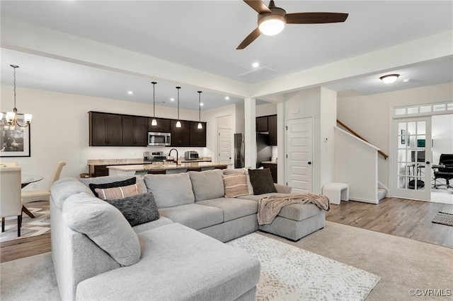 18325 Palisades Ct, Moseley, VA 23120 - living room featuring stairway, a ceiling fan, a chandelier, recessed lighting, and light wood-type flooring