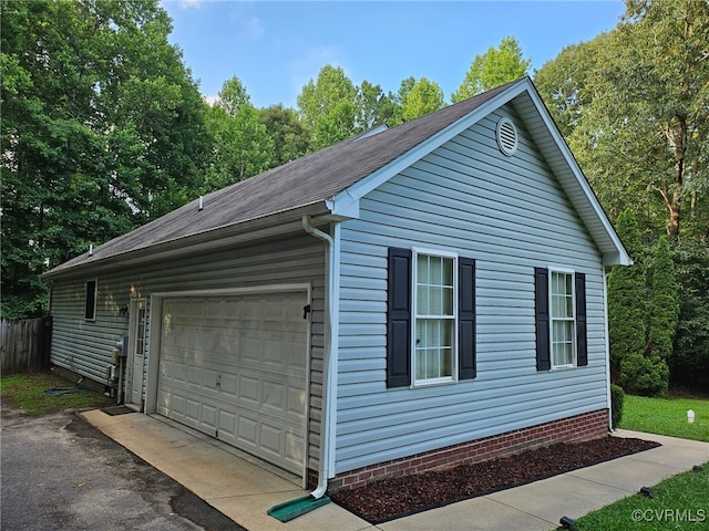 4740 Old Williamsburg Rd, Sandston, VA 23150 - view of side of property with a shingled roof and a detached garage