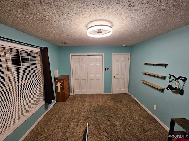 4740 Old Williamsburg Rd, Sandston, VA 23150 - unfurnished bedroom with carpet flooring, a closet, and a textured ceiling
