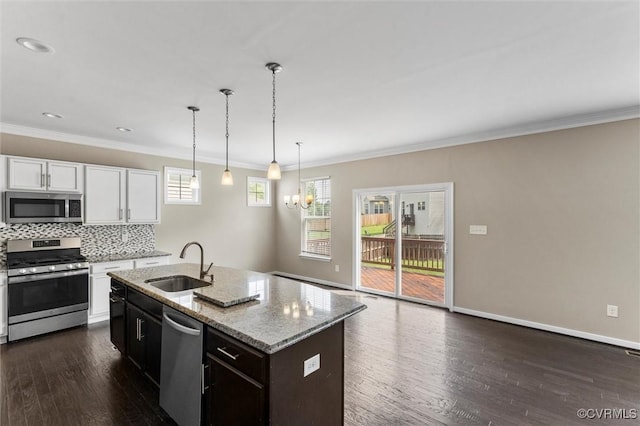 17412 Trevino Pkwy, Moseley, VA 23120 - kitchen with stainless steel appliances, dark wood-style flooring, light stone countertops, white cabinetry, and tasteful backsplash