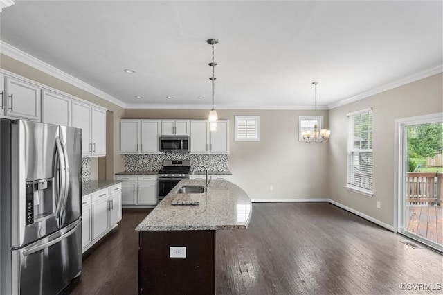 17412 Trevino Pkwy, Moseley, VA 23120 - kitchen with appliances with stainless steel finishes, a chandelier, healthy amount of natural light, decorative backsplash, and crown molding