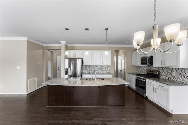 17412 Trevino Pkwy, Moseley, VA 23120 - kitchen with stainless steel appliances, tasteful backsplash, a center island with sink, dark wood finished floors, and crown molding