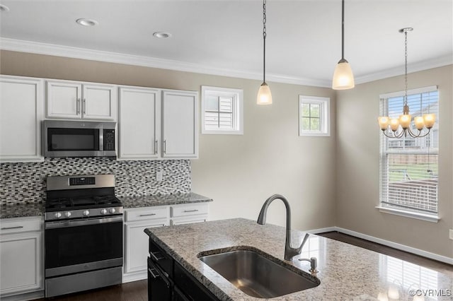 17412 Trevino Pkwy, Moseley, VA 23120 - kitchen featuring stainless steel appliances, crown molding, tasteful backsplash, white cabinets, and decorative light fixtures