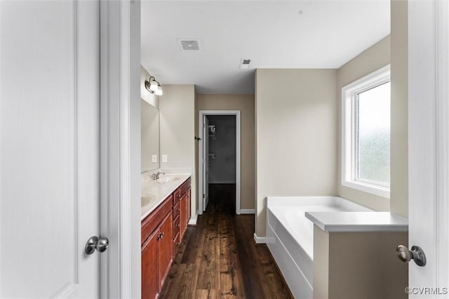 17412 Trevino Pkwy, Moseley, VA 23120 - bathroom with double vanity, wood finished floors, and a garden tub