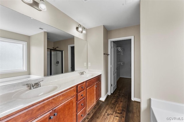 17412 Trevino Pkwy, Moseley, VA 23120 - full bath with double vanity, a bath, a stall shower, and wood finished floors
