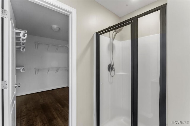 17412 Trevino Pkwy, Moseley, VA 23120 - bathroom with a stall shower, wood finished floors, and a walk in closet