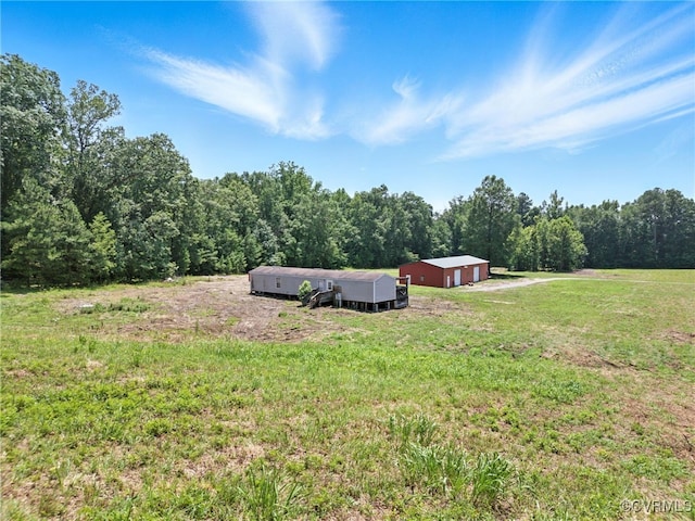 33419 Richmond Tpke, Hanover, VA 23069 - view of green lawn with a garage, a pole building, an outdoor structure, and a view of trees