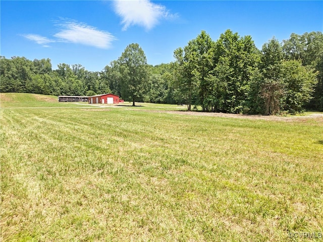 33419 Richmond Tpke, Hanover, VA 23069 - view of grassy yard featuring a forest view, a view of countryside, an outdoor structure, and a pole building