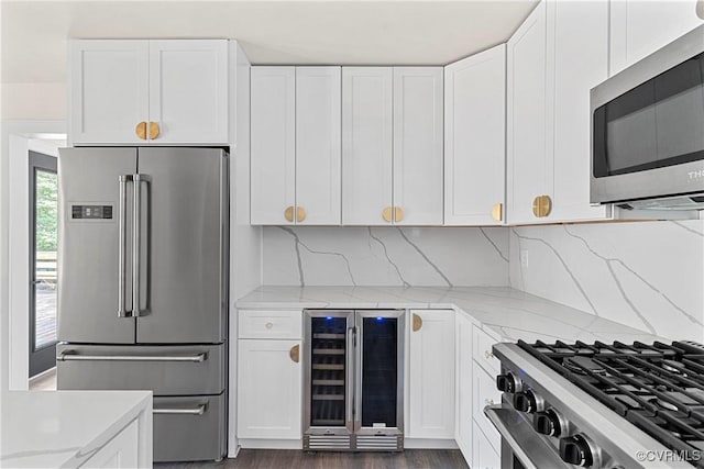 113 Rappa Run Rd, Topping, VA 23169 - kitchen featuring high quality appliances, beverage cooler, light stone counters, and white cabinetry