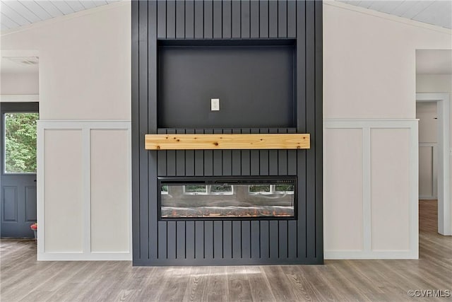 113 Rappa Run Rd, Topping, VA 23169 - detailed view of wood finished floors, a decorative wall, a fireplace, and crown molding