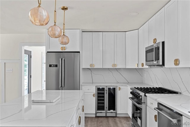 113 Rappa Run Rd, Topping, VA 23169 - kitchen with premium appliances, beverage cooler, light stone countertops, and white cabinetry
