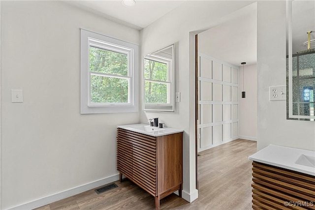 113 Rappa Run Rd, Topping, VA 23169 - full bathroom with two vanities and wood finished floors