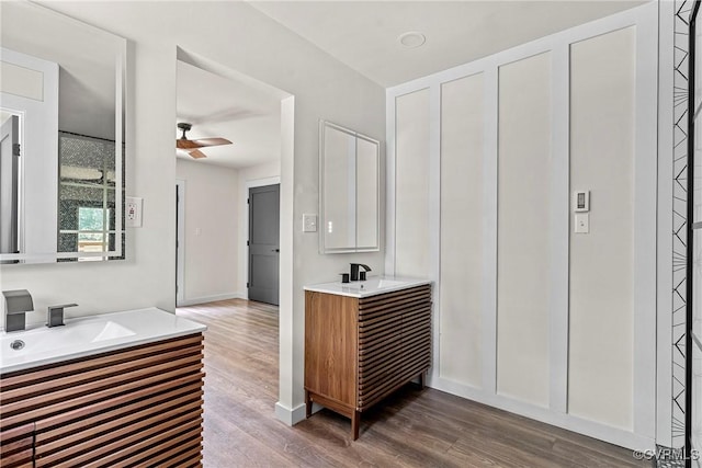 113 Rappa Run Rd, Topping, VA 23169 - bathroom featuring two vanities, wood finished floors, and ceiling fan