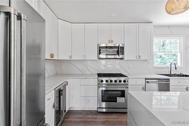 113 Rappa Run Rd, Topping, VA 23169 - kitchen with appliances with stainless steel finishes, light stone counters, dark wood-type flooring, and wine cooler