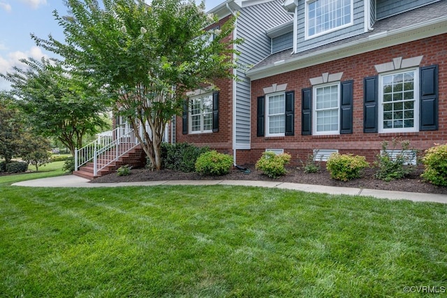 15585 Fox Cove Cir, Moseley, VA 23120 - view of home's exterior with a yard, brick siding, and roof with shingles