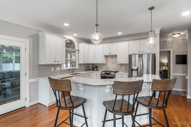 15585 Fox Cove Cir, Moseley, VA 23120 - kitchen featuring appliances with stainless steel finishes, tasteful backsplash, white cabinetry, a breakfast bar, and ornamental molding