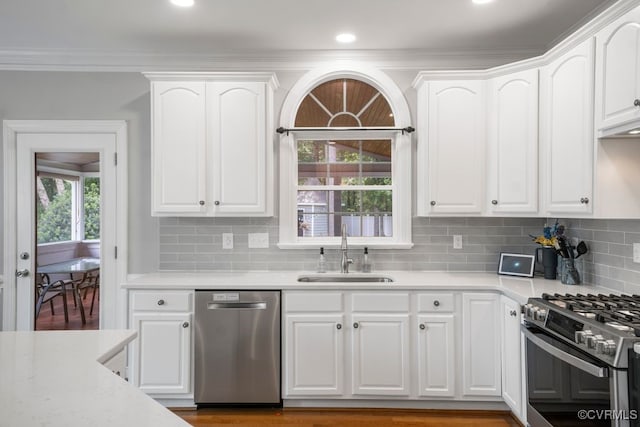 15585 Fox Cove Cir, Moseley, VA 23120 - kitchen with appliances with stainless steel finishes, white cabinetry, light countertops, backsplash, and crown molding