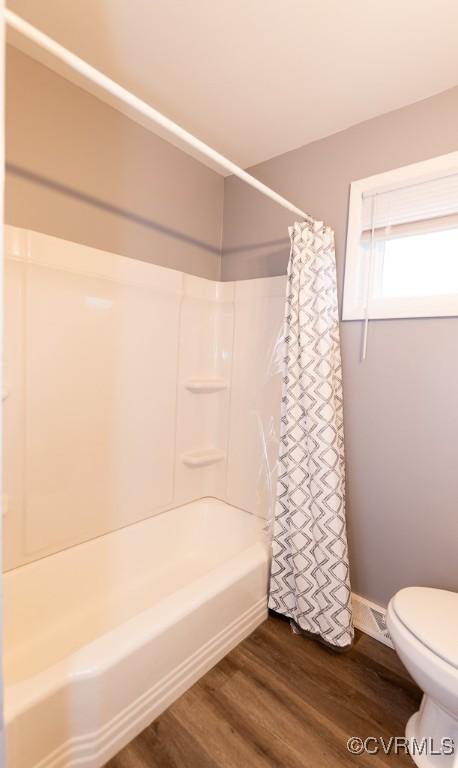 64 Gibbons Ave, Petersburg, VA 23803 - bathroom with shower / bath combination with curtain and wood finished floors