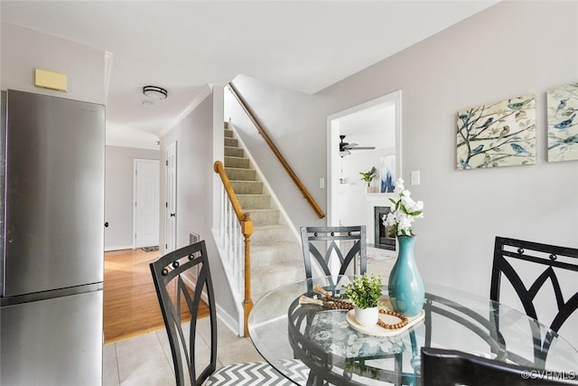 1712 Porters Mill Ln, Midlothian, VA 23114 - staircase featuring ceiling fan, tile patterned floors, a fireplace, and ornamental molding