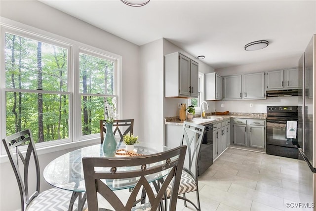 1712 Porters Mill Ln, Midlothian, VA 23114 - kitchen featuring black / electric stove, gray cabinetry, under cabinet range hood, dishwasher, and light tile patterned floors