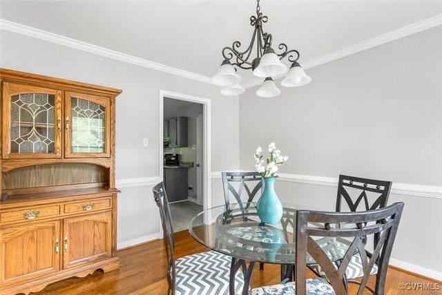 1712 Porters Mill Ln, Midlothian, VA 23114 - dining room with a chandelier, light wood-style flooring, and crown molding