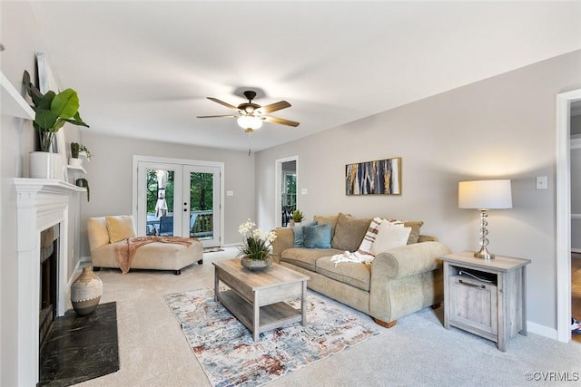 1712 Porters Mill Ln, Midlothian, VA 23114 - living room with light colored carpet, a ceiling fan, french doors, and a fireplace with flush hearth