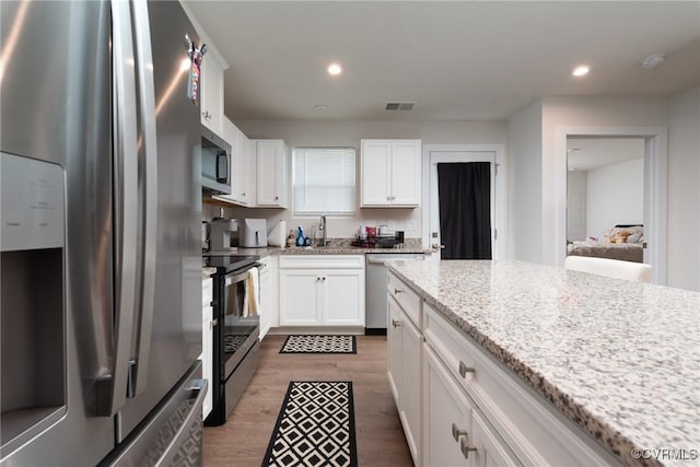 6740 Edith Oaks Way Unit 6740, Chesterfield, VA 23234 - kitchen featuring stainless steel appliances, white cabinets, wood finished floors, recessed lighting, and light stone countertops