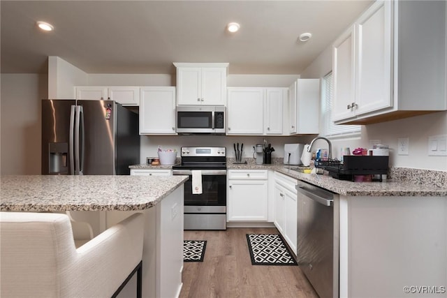 6740 Edith Oaks Way Unit 6740, Chesterfield, VA 23234 - kitchen with stainless steel appliances, light wood-style floors, white cabinetry, light stone counters, and recessed lighting