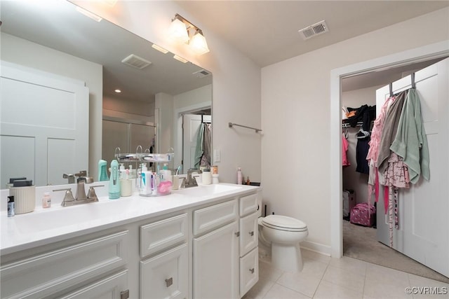 6740 Edith Oaks Way Unit 6740, Chesterfield, VA 23234 - bathroom featuring a shower stall, double vanity, tile patterned floors, and a spacious closet