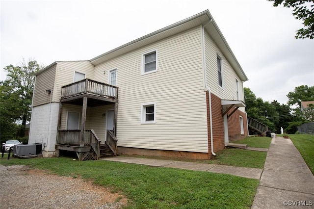 407 E 2nd St, Farmville, VA 23901 - back of property featuring a balcony, a yard, and brick siding