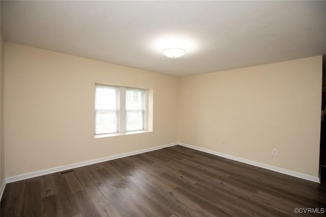 407 E 2nd St, Farmville, VA 23901 - unfurnished room with baseboards and dark wood-type flooring