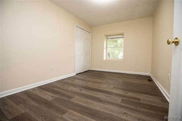 407 E 2nd St, Farmville, VA 23901 - unfurnished bedroom featuring dark wood-style floors and a closet